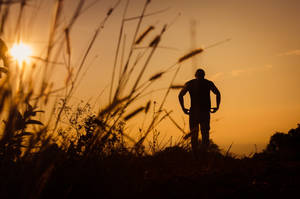 Man In A Field Sad 4k Wallpaper