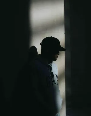 Man In Cap In The Darkness Wallpaper