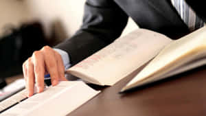 Man In Suit Reading Contract Books Wallpaper