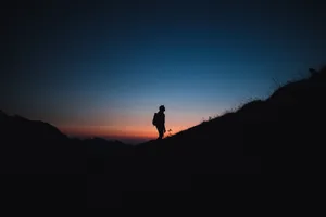 Man On Slope Alone Phone Background Wallpaper