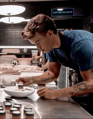 Man Plating Dessertin Kitchen Wallpaper