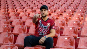 Man Pointingin Stadium Seats Wallpaper