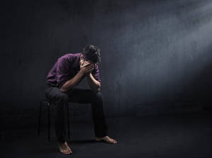 Man Sitting Barefoot Sad 4k Wallpaper