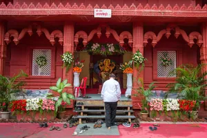 Man Visiting A Vinayaka Shrine Wallpaper