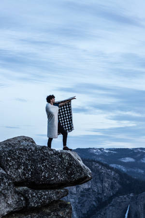 Man With Checkered Blanket Wallpaper