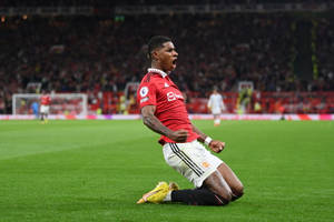 Marcus Rashford Kneeling In Celebration Wallpaper