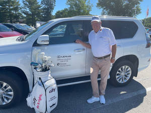 Mark O'meara Posing With Lexus Suv Wallpaper