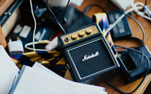 Marshall Speaker On Messy Table Wallpaper