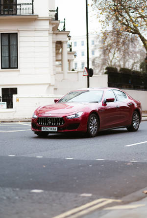 Maserati Car On Paved Road Wallpaper