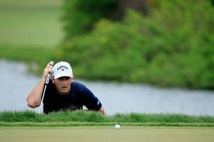 Matt Every Examining Golf Ball Wallpaper