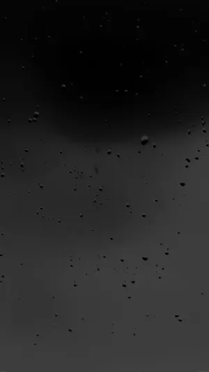 Matte Blacki Phonewith Water Droplets Wallpaper