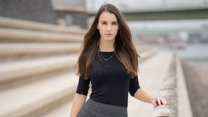 Mature Woman Posing On Large Stone Steps Wallpaper