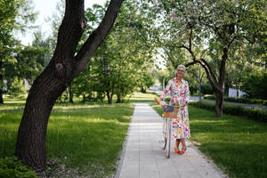 Mature Woman With Her Bicycle Wallpaper