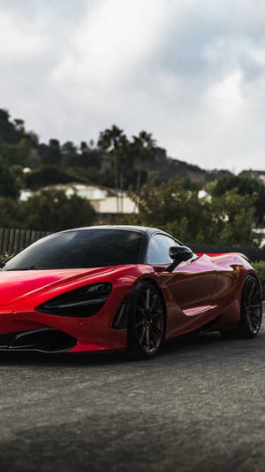 Mclaren 720s Red Car On Grass Phone Wallpaper
