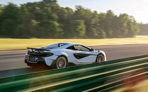 Mclaren Spyder Racing At Track Wallpaper