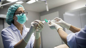 Medical Surgeon Using Syringe Wallpaper