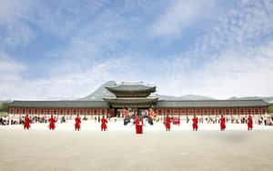 Men In Red At Gyeongbokgung Palace Wallpaper