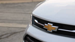 Mighty Chevrolet Camaro Roaring On A Sunny Highway Wallpaper