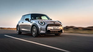 Mini Gray Car Under Sunset Wallpaper