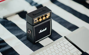 Mini Marshall Amplifier Near Keyboard Wallpaper