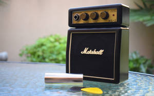 Mini Marshall Amplifier On Table Wallpaper