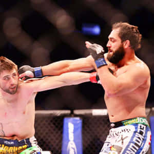 Mma Fighter Johny Hendricks Delivering A Long Jab Wallpaper