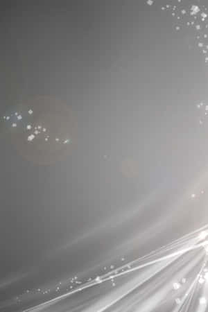 Modern Light Gray Iphone Against A Black Background. Wallpaper