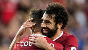 Mohamed Salah Hugging His Teammate Wallpaper