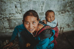 Mom And Son Carrying On The Back Wallpaper