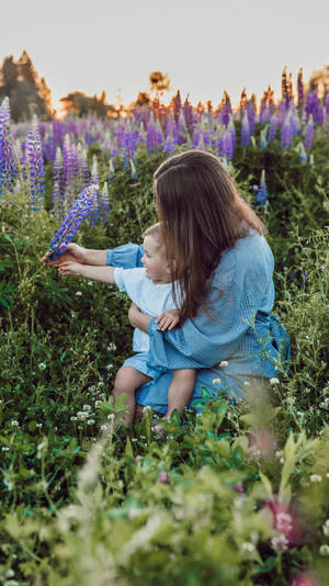 Mom And Son Field Of Flowers Wallpaper