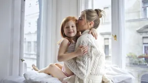 Mom Kissing Little Girl Wallpaper