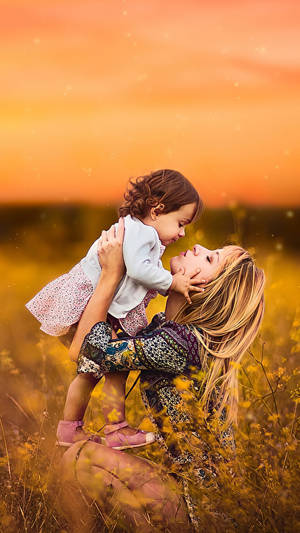 Mother And Daughter In Flower Garden Wallpaper