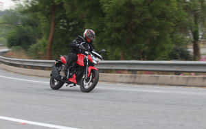 Motorcyclistin Motionon Highway.jpg Wallpaper