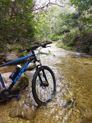 Mountain Bike At Stream Wallpaper