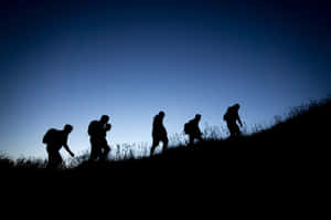 Mountain Hiking Group Of Friends With Backpacks Wallpaper