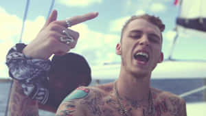 Multi Talented Artist Mgk Performing For An Adoring Crowd Wallpaper