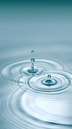 Multiple Droplets On Rippling Water Wallpaper