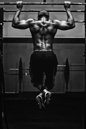 Muscular Man Performing Pull Up Workout Wallpaper