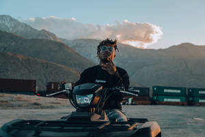 Music Sensation Juice Wrld Riding An Atv Wallpaper