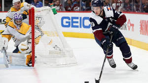 Nathan Mackinnon Playing Against Opponent Wallpaper