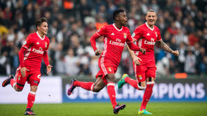 Nelson Semedo Running With His Teammates Wallpaper