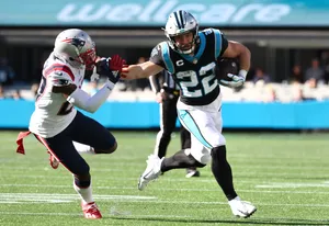 New England Patriots Jc Jackson Tries To Tackle Christian Mccaffrey Wallpaper