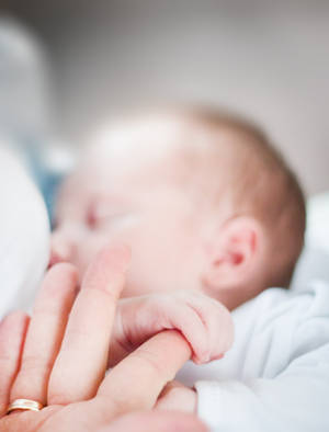 Newborn Baby Girl Gripping Wallpaper