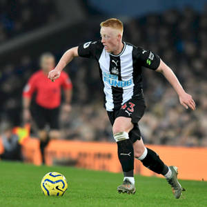 Newcastle United Fc Player Kicking Ball Wallpaper