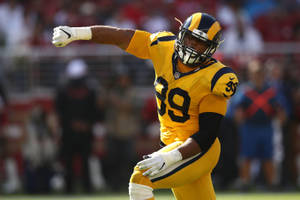 Nfl Athlete Aaron Donald Yellow Jersey Wallpaper