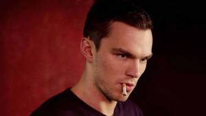 Nicholas Hoult Capturing A Rugged, Relaxed Moment With A Cigarette Wallpaper