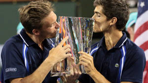 Nicolas Mahut And Herbert Kissing Trophy Wallpaper