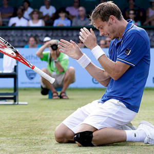 Nicolas Mahut Passionately Throwing His Racket In A Tennis Match Wallpaper