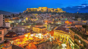 Night-time Panorama Of The Majestic Athens Acropolis Wallpaper