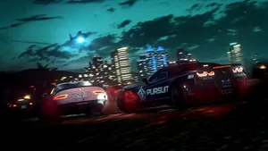 Nighttime Police Pursuit Cityscape Wallpaper